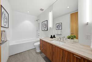 Full bath with vanity, bathtub / shower combination, and recessed lighting