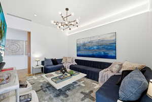 Living room featuring a chandelier and wood finished floors
