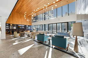 Lobby with wood ceiling, a towering ceiling, and wood walls