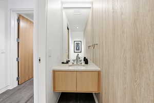 Bathroom featuring vanity and wood walls