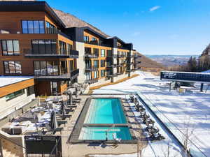 Community pool with a mountain view and a patio