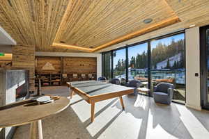 Recreation room with wooden ceiling and floor to ceiling windows