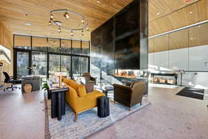 Community lobby featuring a high ceiling, expansive windows, and wooden ceiling