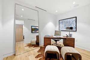Office space featuring recessed lighting and light wood-style flooring