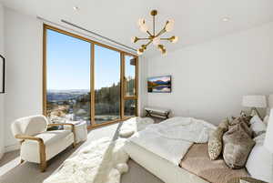 Bedroom featuring carpet floors, a chandelier, floor to ceiling windows, and recessed lighting