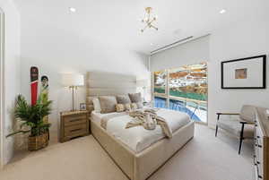 Bedroom with access to outside, light carpet, a chandelier, and recessed lighting