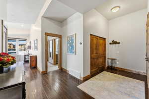 Entryway featuring dark wood-type flooring and a textured ceiling