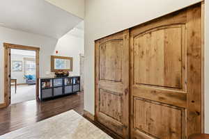 Corridor featuring dark wood-type flooring and a textured ceiling