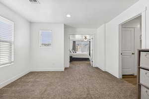 Hallway featuring dark carpet and recessed lighting