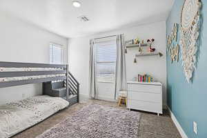 Bedroom featuring carpet flooring and baseboards