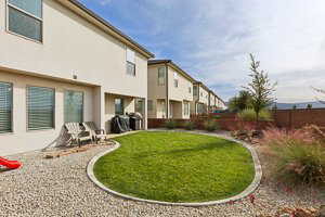 Fenced backyard featuring a residential view