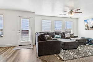 Living room with wood finished floors and ceiling fan