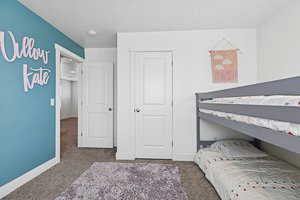 Bedroom featuring carpet flooring and baseboards