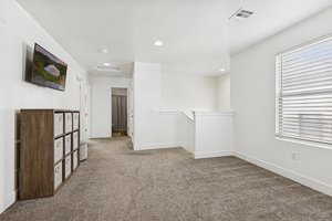Unfurnished living room with carpet floors and recessed lighting