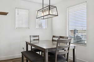 Dining area featuring radiator, wood finished floors, and a chandelier