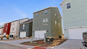 View of property exterior with concrete driveway, a garage, and stucco siding