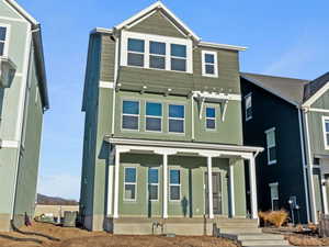 View of front facade featuring covered porch and board and batten siding