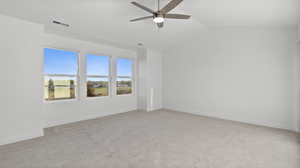 Unfurnished room with vaulted ceiling, light carpet, and ceiling fan