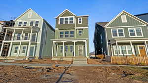 View of front of house featuring board and batten siding, a balcony, and a porch