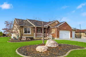 Ranch-style home with a front yard, a porch, brick siding, and concrete driveway