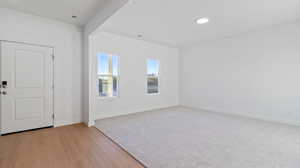 Spare room with light wood finished floors and recessed lighting