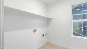 Laundry room with washer hookup, light tile patterned floors, and electric dryer hookup