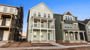 View of front of home with board and batten siding and covered porch