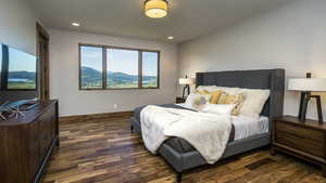 Bedroom with a mountain view, dark wood-style flooring, and recessed lighting. Previously built Ridge unit. Photos are for illustration purposes only.
