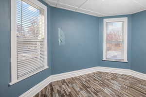 Bedroom featuring wood finished floors and baseboards