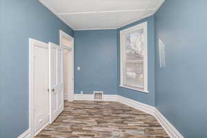Bedroom featuring wood finished floors and baseboards