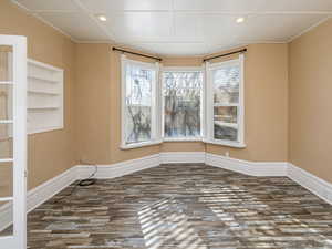 Unfurnished room with dark wood-style floors and recessed lighting