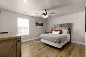 Bedroom with light wood-type flooring, ceiling fan, and recessed lighting