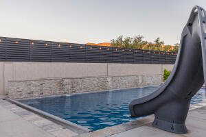 Pool at dusk with a water slide