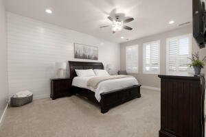 Bedroom with light colored carpet, ceiling fan, and recessed lighting