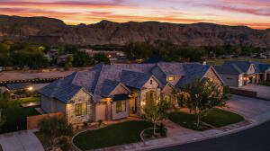 View of front of property featuring a mountain view and driveway