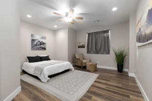 Bedroom with dark wood-type flooring, recessed lighting, and a ceiling fan