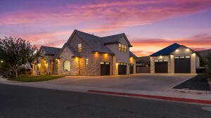 French country home featuring driveway and a garage