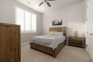 Bedroom with light carpet, ceiling fan, and recessed lighting