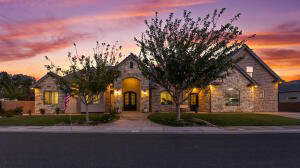 French country home featuring stone siding and a front lawn
