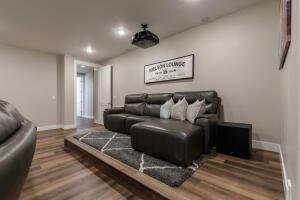 Cinema with dark wood-style floors and recessed lighting