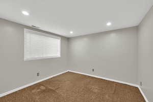 Empty room featuring carpet and recessed lighting