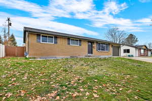 Ranch-style house with brick siding and a garage