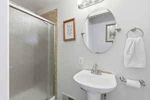 Bathroom featuring a stall shower and a textured ceiling