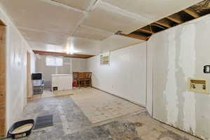 Basement featuring refrigerator