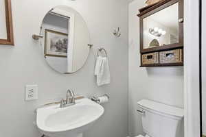 Half bathroom with a sink and toilet