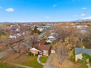 Aerial view of property and surrounding area featuring mountains