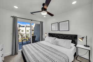 Bedroom featuring carpet, ceiling fan, access to outside second story covered patio, and recessed lighting.