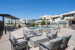 Private Cole West hot tub with a patio, a pergola, an outdoor living space, and a residential view