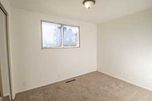 Unfurnished bedroom with a closet and carpet flooring