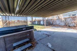 View of patio with a hot tub
